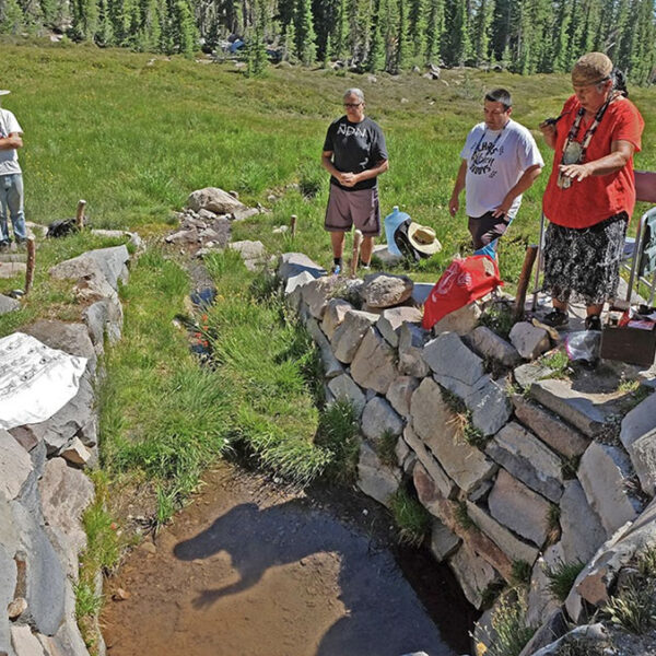 Mt. Shasta, CA — The Winnemem Wintu gather once a year at a sacred spring on Mt. Shasta where they believe the world began. Chief Caleen Sisk, in red, gestures as she prays. July 9, 2021. Tom Levy/The Spiritual Edge