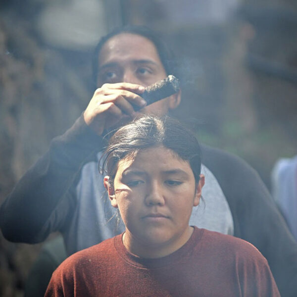Lower McCloud River Falls, CA — Nick Wilson smudges a young member of the Winnemem Wintu tribe before the “Salmon Challenge” begins. — July 10, 2019